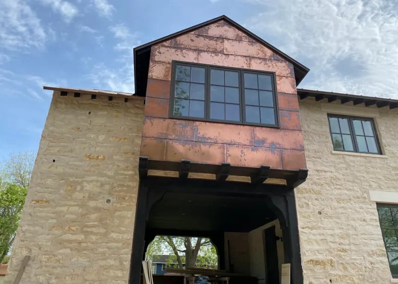 Copper metal panel facade on a stone building for Skylight Installation in West Clarkston-Highland